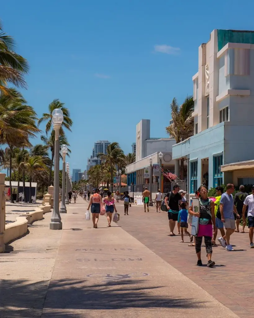 Hollywood beach boardwalk with people strolling 
