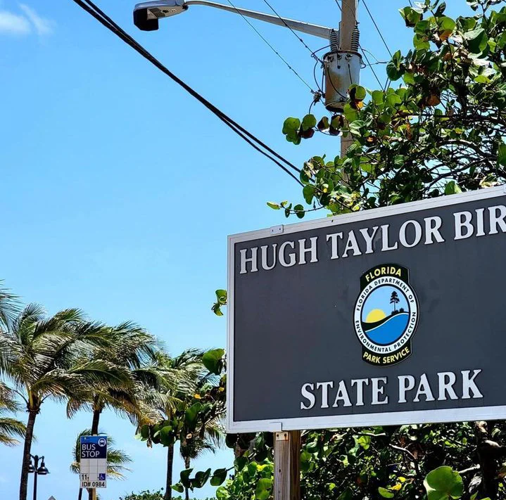 a sign post that says "HUGH TAYLOR BIRCH STATE PARK"

